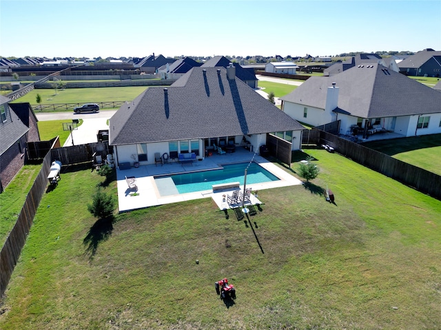 view of swimming pool featuring a yard and a patio