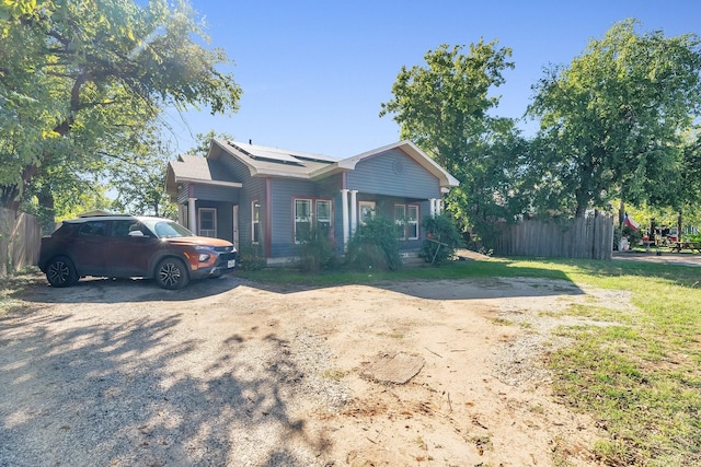 ranch-style house with solar panels