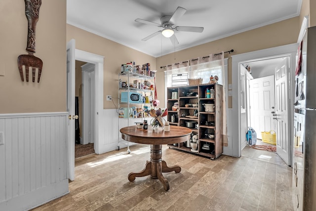 interior space featuring ceiling fan, light hardwood / wood-style flooring, and crown molding