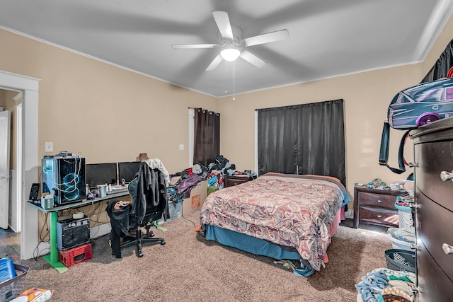 carpeted bedroom featuring ceiling fan and ornamental molding