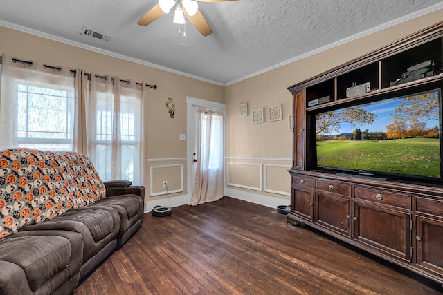 living room featuring a textured ceiling, ceiling fan, crown molding, and dark wood-type flooring