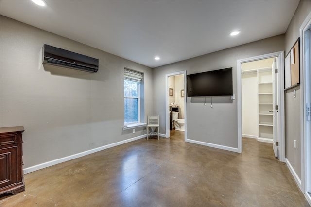 unfurnished living room featuring a wall unit AC