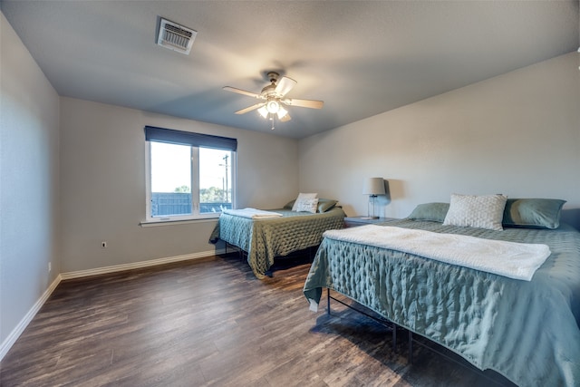 bedroom featuring ceiling fan and dark hardwood / wood-style floors