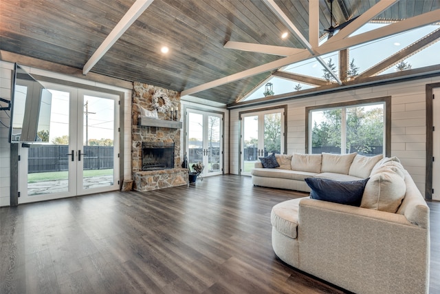 living room with vaulted ceiling with beams, plenty of natural light, and wood ceiling