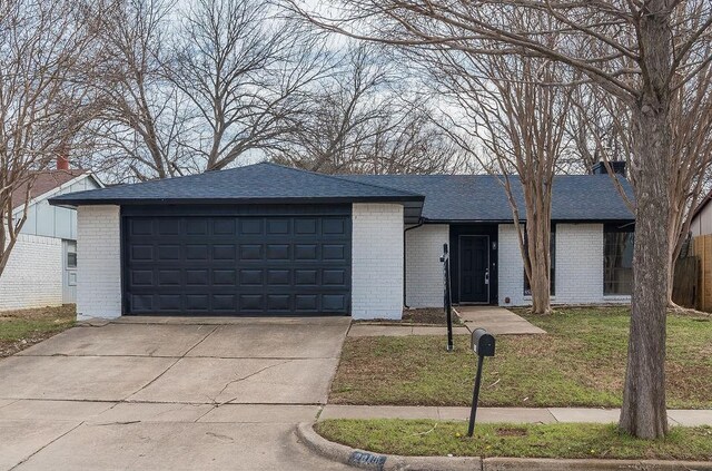 ranch-style home with a front yard and a garage