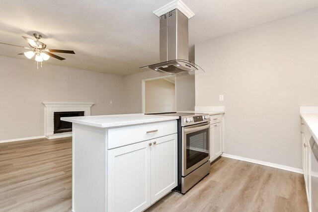 kitchen with island range hood, electric stove, kitchen peninsula, and white cabinetry