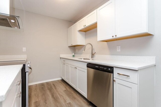 kitchen featuring white cabinetry, appliances with stainless steel finishes, light countertops, and a sink