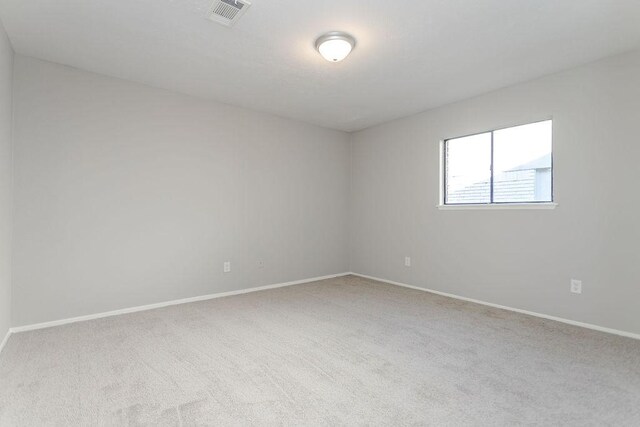 unfurnished room with light colored carpet