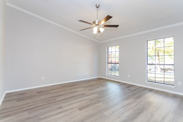 spare room featuring baseboards, ornamental molding, ceiling fan, and wood finished floors