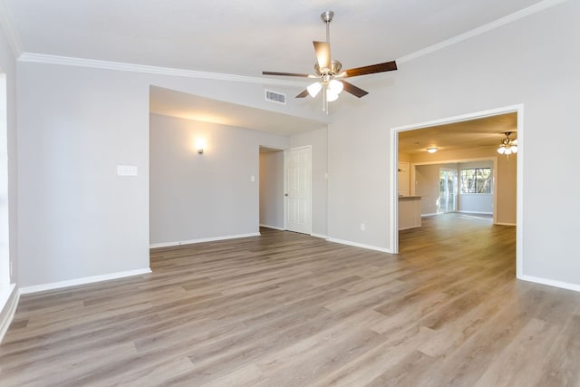 empty room with ornamental molding, light wood-style flooring, and visible vents