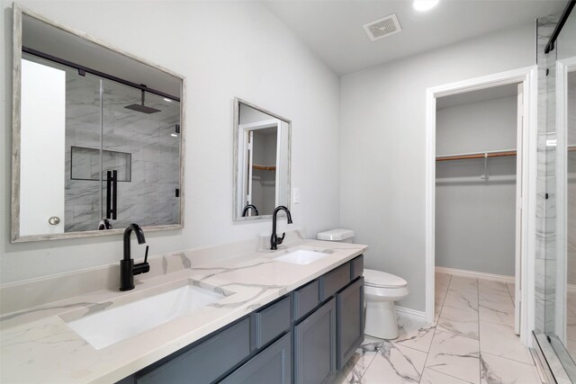 bathroom with walk in shower, vanity, and toilet