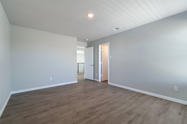 spare room with wood-type flooring