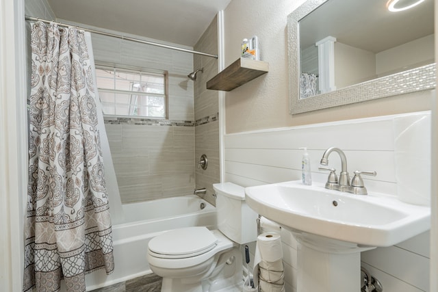 full bathroom with toilet, sink, and shower / tub combo