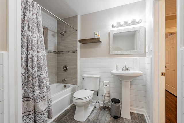 bathroom featuring hardwood / wood-style flooring, toilet, and shower / tub combo with curtain