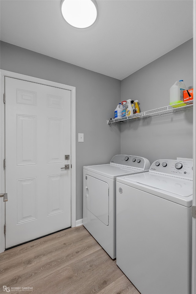 laundry area featuring washer and dryer and light wood-type flooring