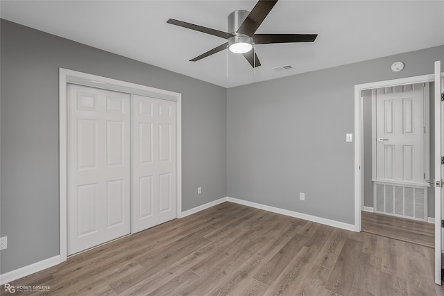 unfurnished bedroom featuring a closet, ceiling fan, and light hardwood / wood-style flooring