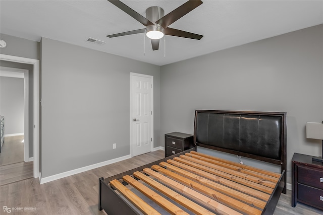 bedroom with light wood-type flooring and ceiling fan