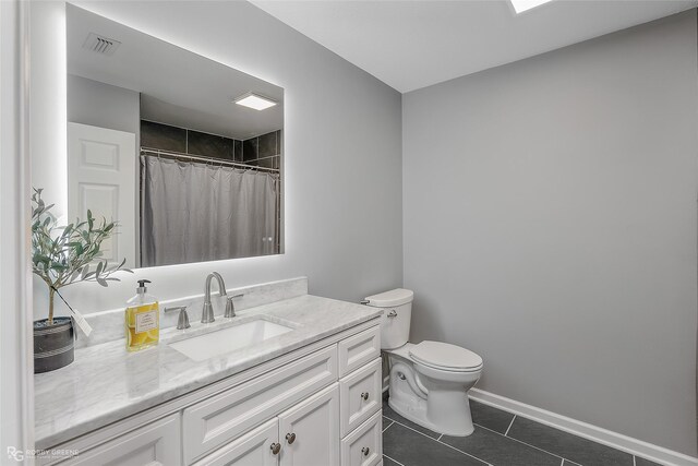 bathroom featuring tile patterned floors, curtained shower, vanity, and toilet