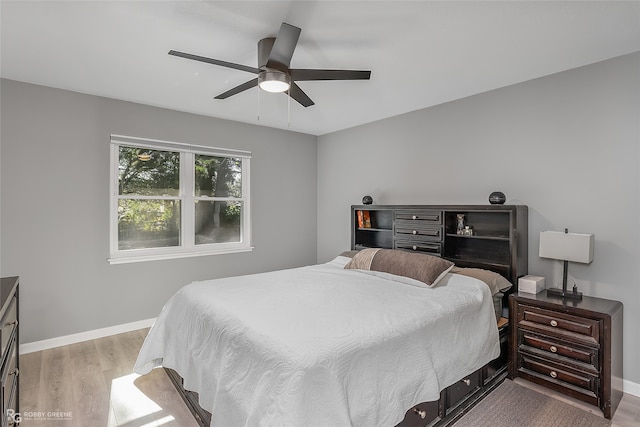 bedroom with ceiling fan and light hardwood / wood-style flooring