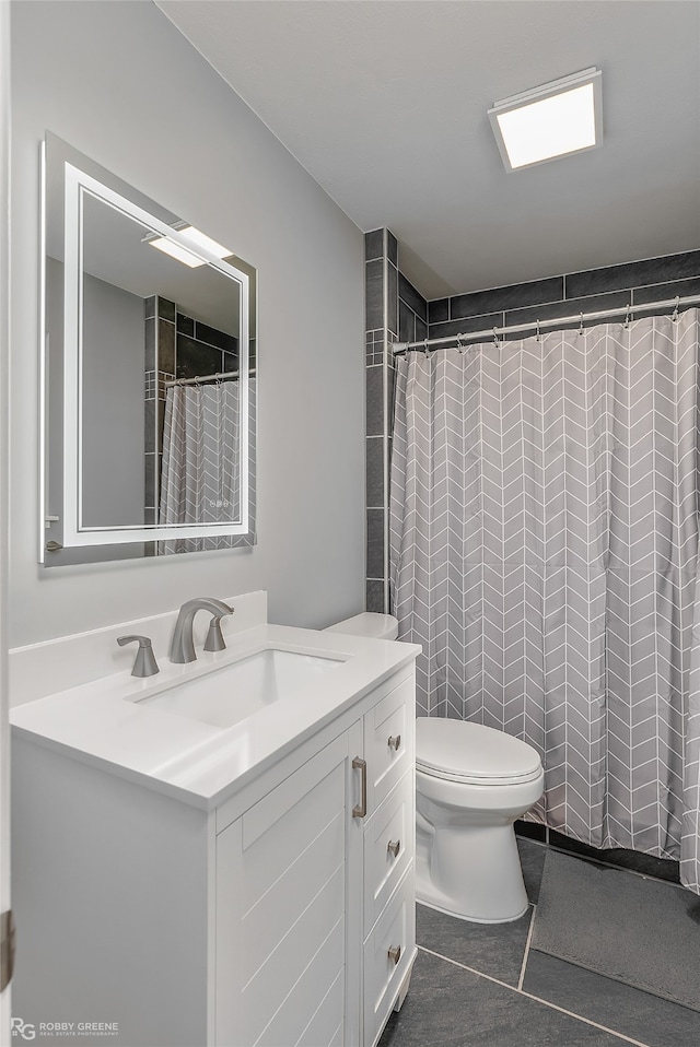 bathroom featuring tile patterned floors, curtained shower, vanity, and toilet