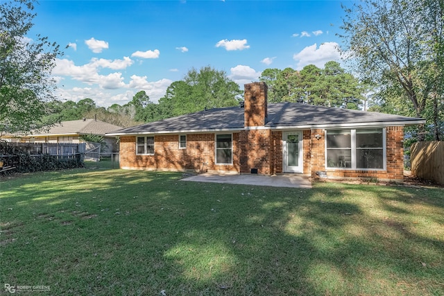 rear view of property featuring a yard and a patio