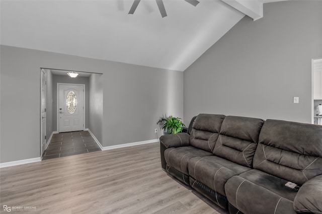 living room with ceiling fan, hardwood / wood-style floors, and lofted ceiling with beams