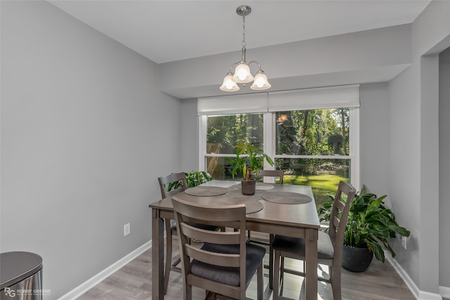 dining area featuring a chandelier and light hardwood / wood-style flooring