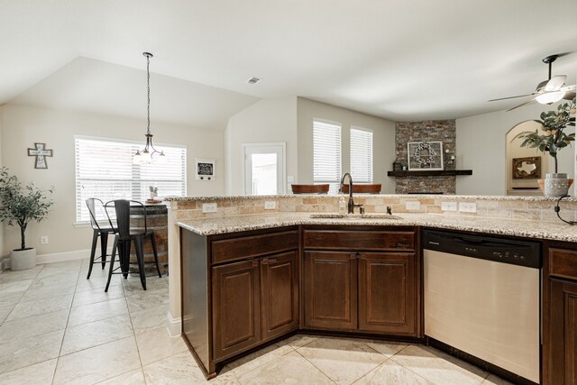 kitchen with vaulted ceiling, stainless steel dishwasher, plenty of natural light, and sink