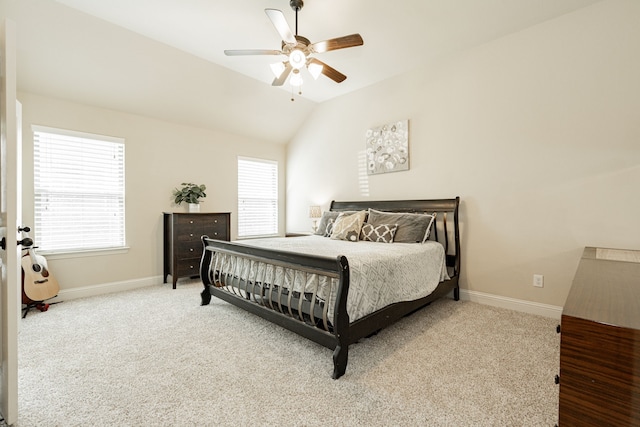 bedroom featuring carpet flooring, vaulted ceiling, multiple windows, and ceiling fan