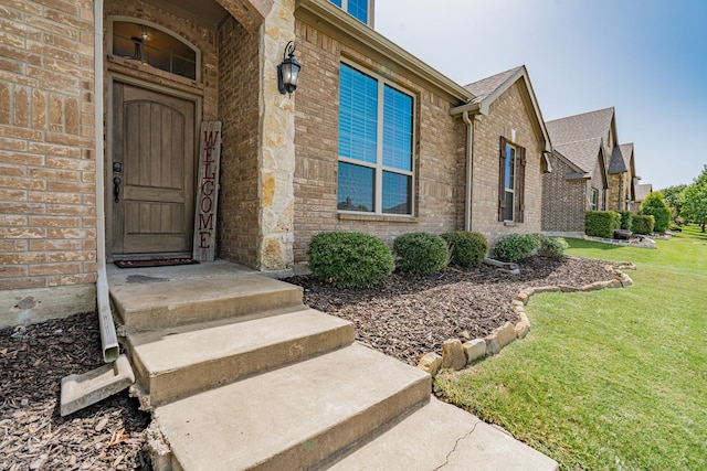 doorway to property with a yard