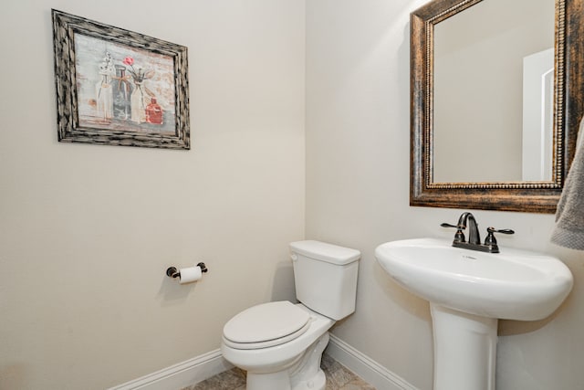 bathroom with tile patterned flooring, toilet, and sink