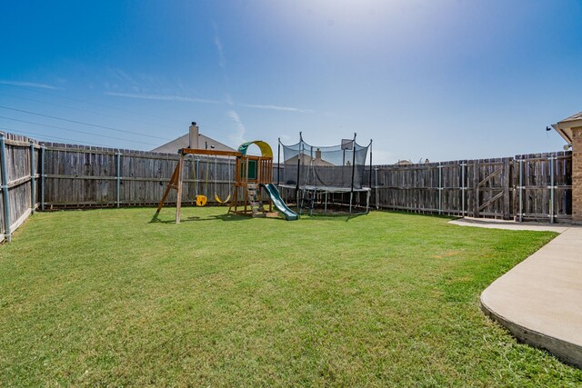 view of yard featuring a playground, a patio, and a trampoline