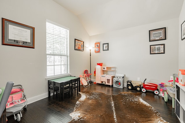 rec room with dark hardwood / wood-style flooring, a healthy amount of sunlight, and vaulted ceiling