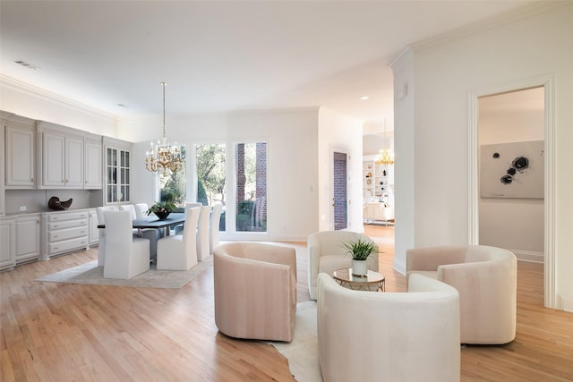 living room featuring ornamental molding, light wood-type flooring, and an inviting chandelier