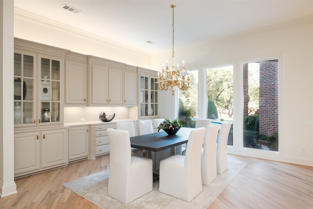 2 Manzano, Dallas, TX 75230 - dining space featuring a chandelier, light wood finished floors, and crown molding