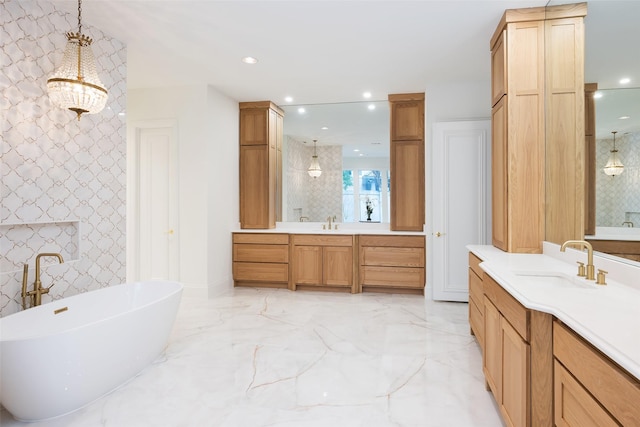 2 Manzano, Dallas, TX 75230 - bathroom featuring recessed lighting, a freestanding bath, two vanities, marble tiled flooring, and baseboards