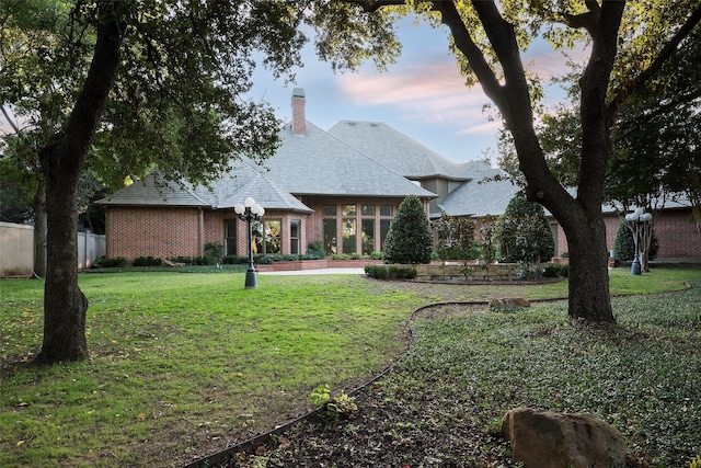 2 Manzano, Dallas, TX 75230 - view of front facade featuring a chimney and brick siding