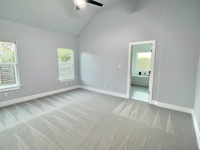 unfurnished room featuring ceiling fan, lofted ceiling, and carpet floors