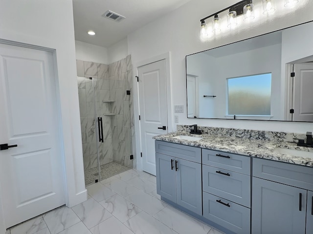 bathroom featuring a shower with door and vanity