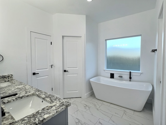 bathroom featuring vanity and a tub