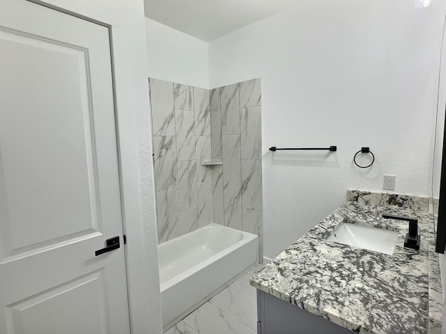 bathroom featuring vanity and tiled shower / bath combo