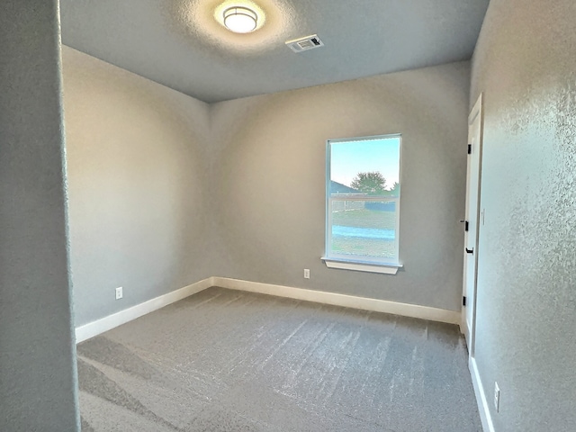 unfurnished room with carpet flooring