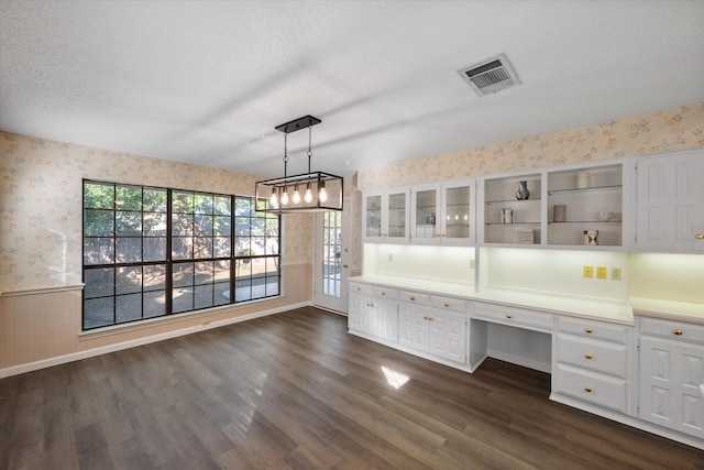5400 Emerald Park Blvd, Arlington, TX 76017 - unfurnished office with wallpapered walls, built in desk, a wainscoted wall, dark wood finished floors, and a textured ceiling