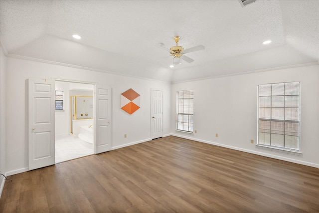 5400 Emerald Park Blvd, Arlington, TX 76017 - unfurnished bedroom with a textured ceiling, vaulted ceiling, wood finished floors, recessed lighting, and baseboards
