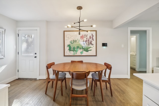 dining room featuring an inviting chandelier and light wood-type flooring