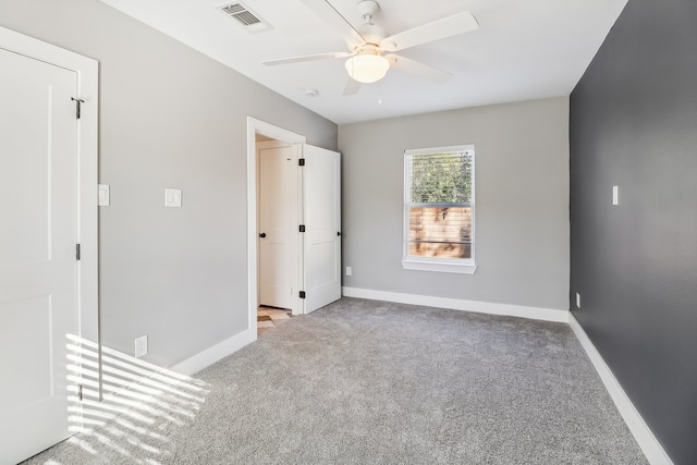 unfurnished bedroom featuring ceiling fan and light carpet