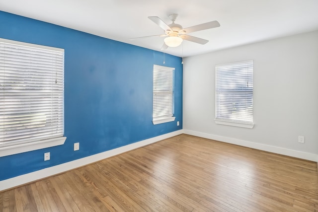 empty room with light wood-type flooring and ceiling fan