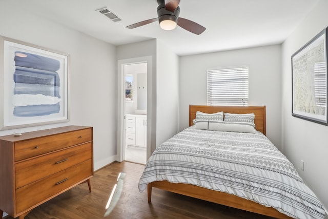 bedroom featuring connected bathroom, ceiling fan, and dark wood-type flooring