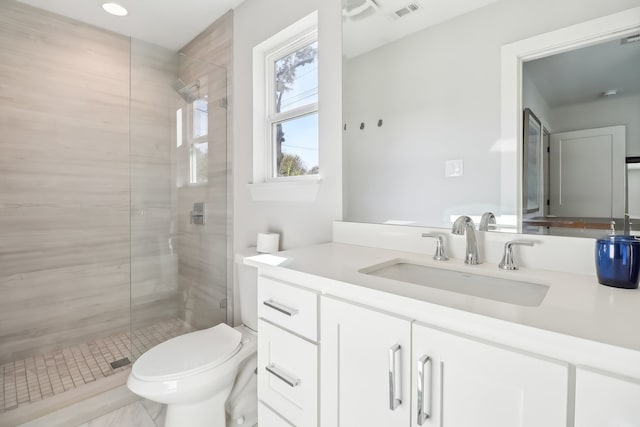 bathroom with vanity, toilet, and an enclosed shower