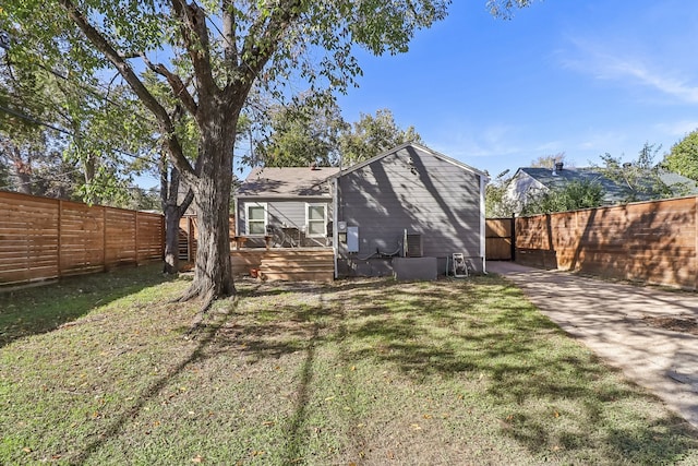 rear view of property with a yard